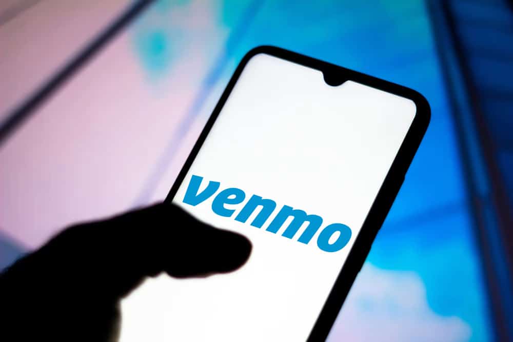 A person holding phone with venmo app opened in phone